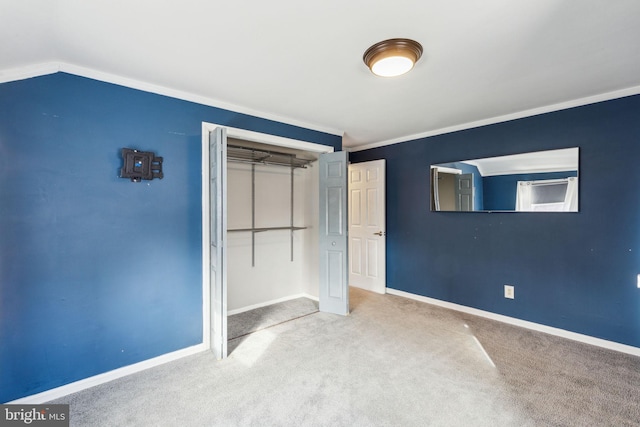 unfurnished bedroom featuring carpet, baseboards, a closet, and ornamental molding