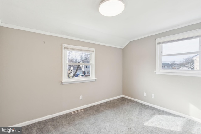 unfurnished room with baseboards, visible vents, a wealth of natural light, and carpet floors