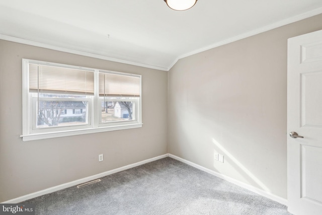 carpeted empty room featuring visible vents, baseboards, and crown molding