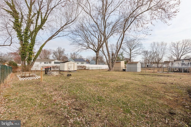 view of yard with an outbuilding, a fenced backyard, and a shed