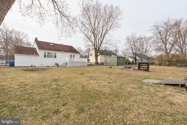 view of yard featuring fence and a wooden deck