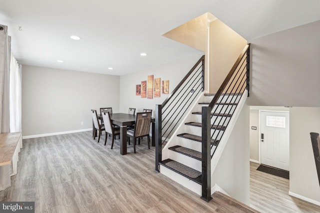 dining room featuring recessed lighting, stairway, baseboards, and wood finished floors