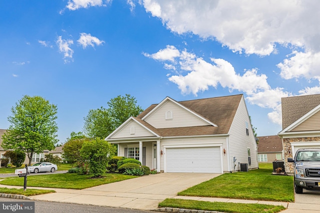 traditional home featuring a front yard, concrete driveway, a garage, and roof with shingles