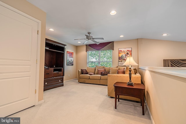 living area featuring ceiling fan, recessed lighting, light colored carpet, and baseboards