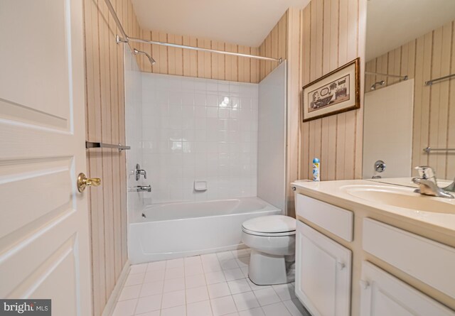 bathroom featuring tile patterned flooring, toilet, vanity, and shower / washtub combination