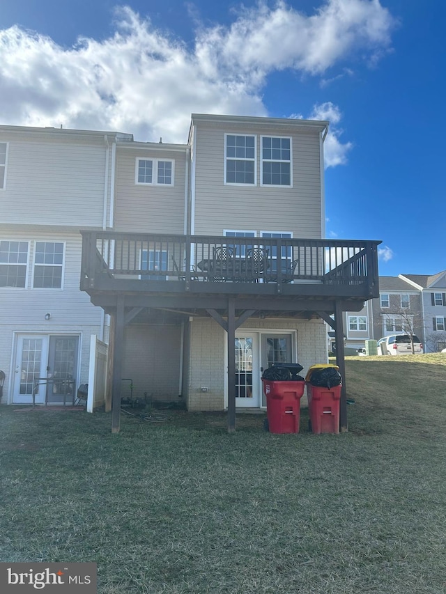 back of house with a lawn and a wooden deck