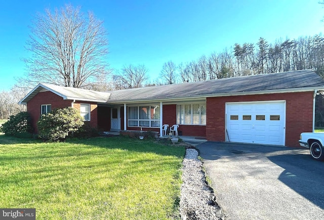 ranch-style house with an attached garage, aphalt driveway, a front yard, covered porch, and brick siding