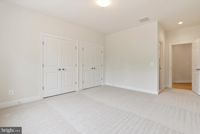 3006 Weber Pl, Oakton, VA 22124 - unfurnished bedroom with multiple closets, light colored carpet, baseboards, and recessed lighting