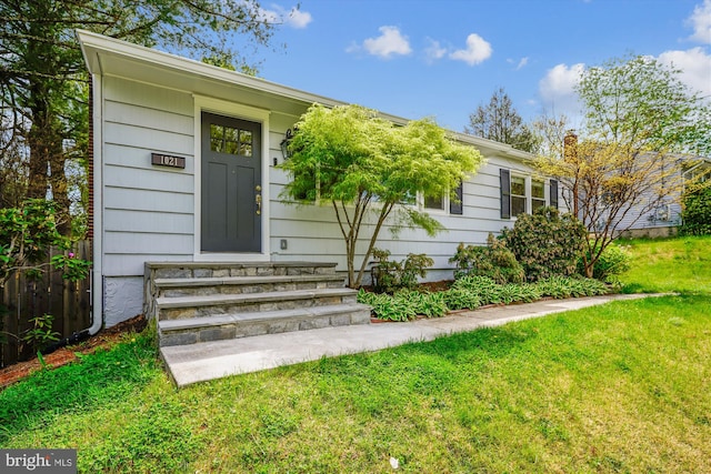 entrance to property with a yard