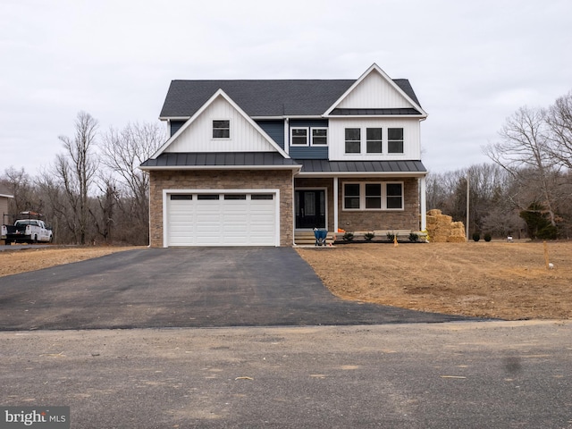 view of front facade with an attached garage, a porch, metal roof, driveway, and a standing seam roof