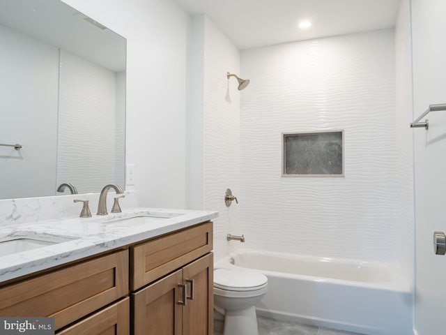 bathroom with double vanity, toilet, washtub / shower combination, and a sink