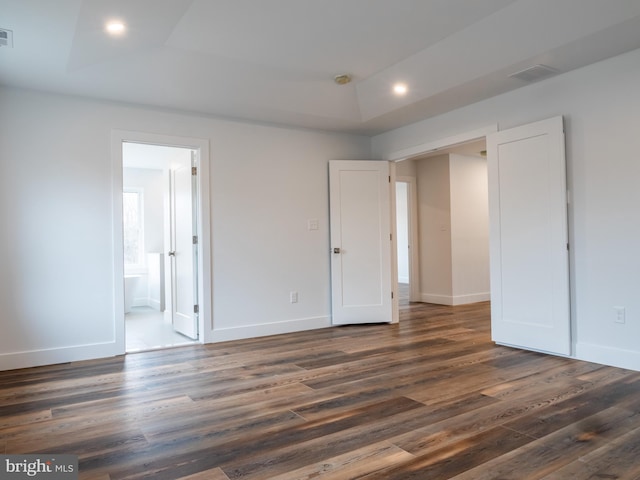 unfurnished bedroom with recessed lighting, dark wood-style floors, and baseboards