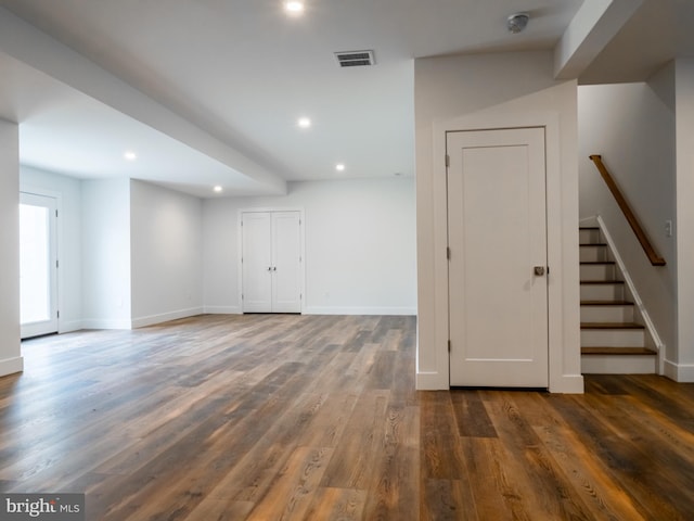 spare room featuring visible vents, wood finished floors, recessed lighting, stairway, and baseboards