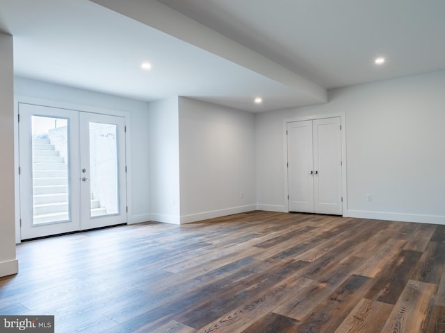 interior space with wood finished floors, french doors, and baseboards