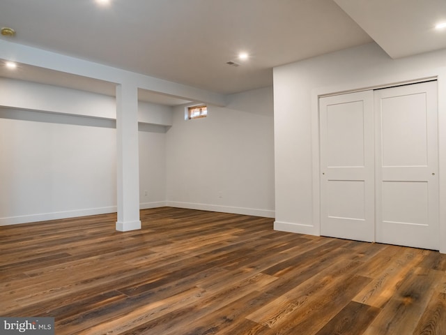 finished below grade area with recessed lighting, dark wood-style flooring, and baseboards