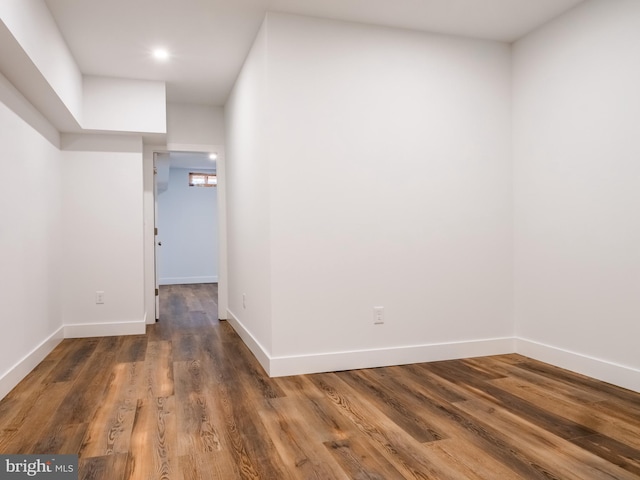 unfurnished room with wood finished floors and baseboards