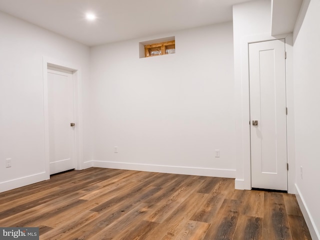 finished basement featuring baseboards and wood finished floors