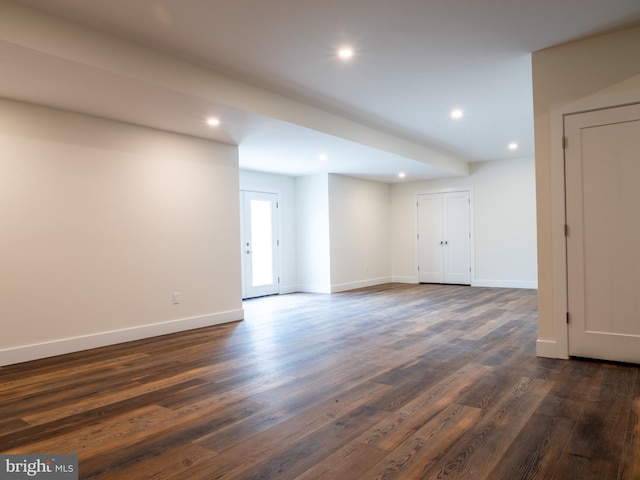 unfurnished room with recessed lighting, dark wood-style floors, and baseboards