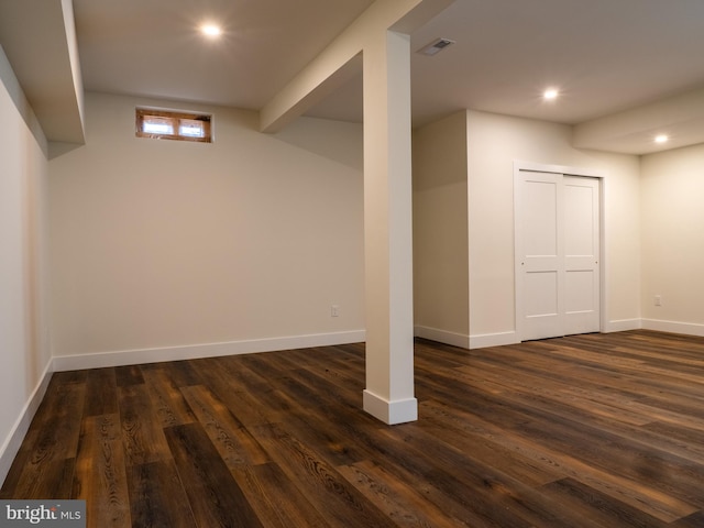 below grade area with recessed lighting, visible vents, baseboards, and dark wood-style floors