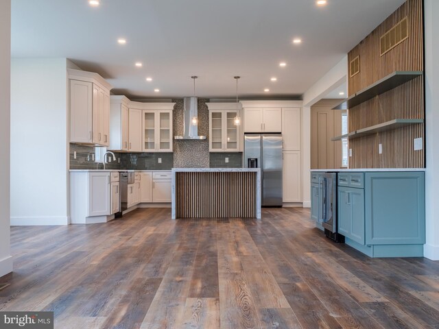 kitchen with backsplash, wall chimney range hood, dark wood-style floors, stainless steel appliances, and open shelves