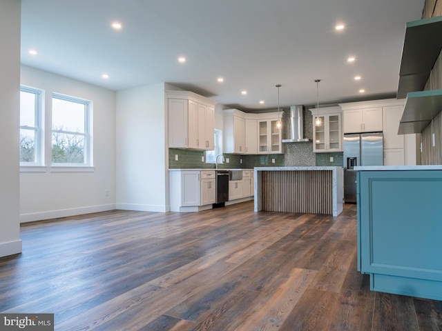 kitchen featuring glass insert cabinets, tasteful backsplash, wall chimney exhaust hood, stainless steel fridge with ice dispenser, and dishwashing machine