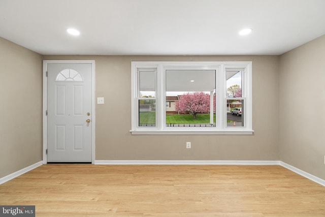 entryway with baseboards, recessed lighting, and light wood-style floors