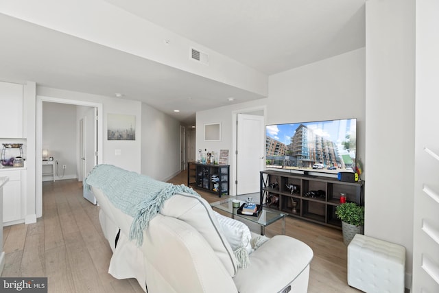 bedroom with light wood-type flooring and visible vents