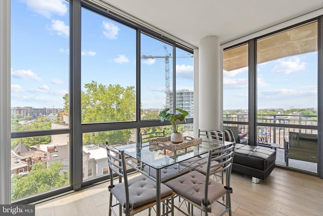 sunroom / solarium featuring a city view and a healthy amount of sunlight