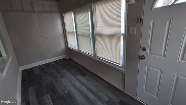 foyer entrance with baseboards and dark wood finished floors