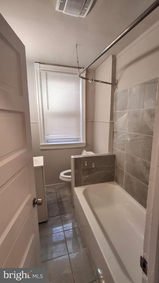 bathroom featuring toilet, vanity, a bath, and a shower