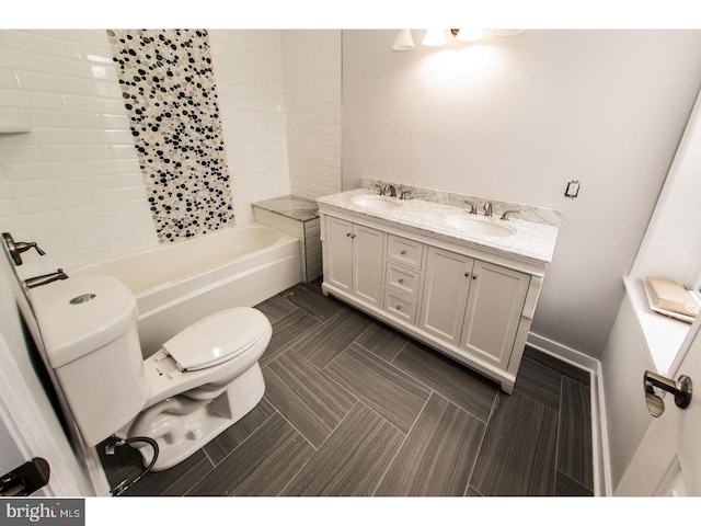 full bath featuring double vanity, toilet, tile patterned floors, and a sink