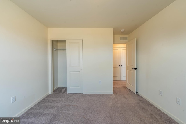 unfurnished bedroom featuring visible vents, baseboards, a closet, and carpet flooring