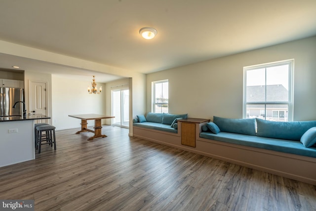 living area with dark wood-style flooring and a chandelier