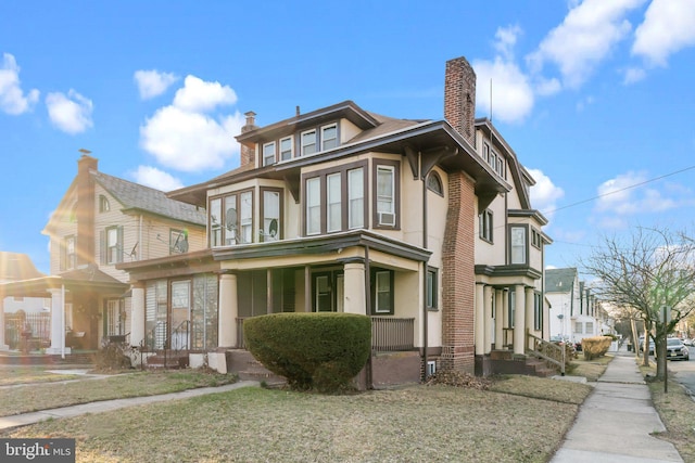 view of property exterior with a chimney and stucco siding