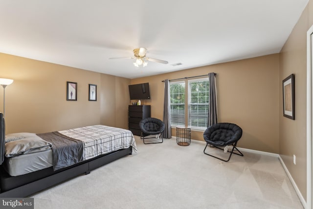 carpeted bedroom with baseboards, visible vents, and a ceiling fan