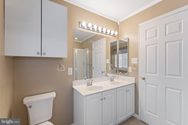 bathroom featuring a stall shower, toilet, crown molding, and a sink