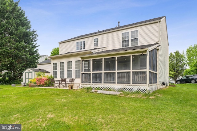 rear view of house featuring a yard, a sunroom, a shed, and an outdoor structure