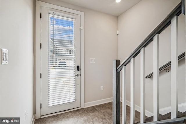 entryway featuring light tile patterned floors and baseboards