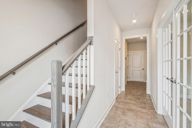stairs featuring tile patterned floors, french doors, and baseboards