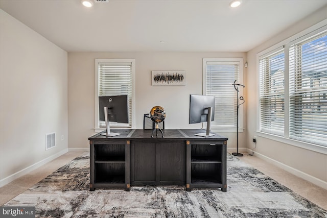 office space featuring light colored carpet, baseboards, visible vents, and recessed lighting