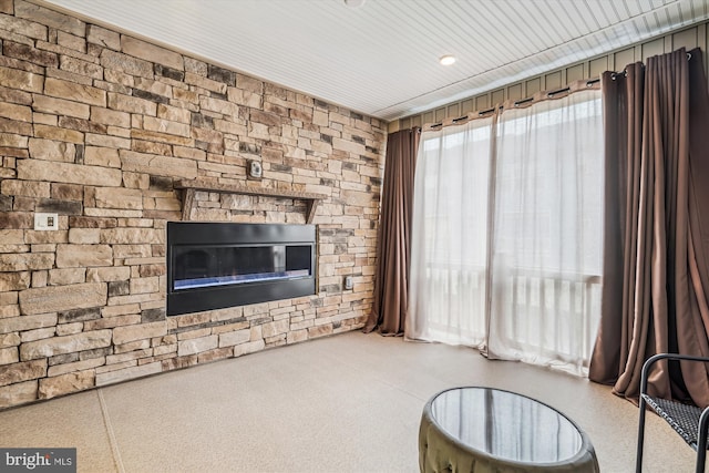 unfurnished living room featuring a stone fireplace