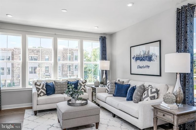 living room featuring recessed lighting, baseboards, and wood finished floors