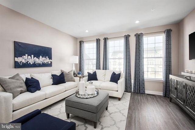 living room with recessed lighting, baseboards, and wood finished floors