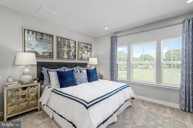 bedroom with recessed lighting, light colored carpet, visible vents, and baseboards