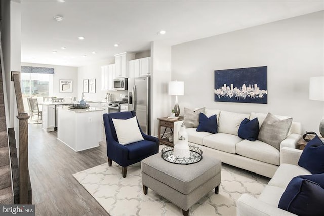 living room with recessed lighting and wood finished floors