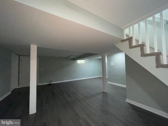 3801 Parkside Dr, Baltimore, MD 21206 - below grade area with dark wood-type flooring, stairs, and baseboards