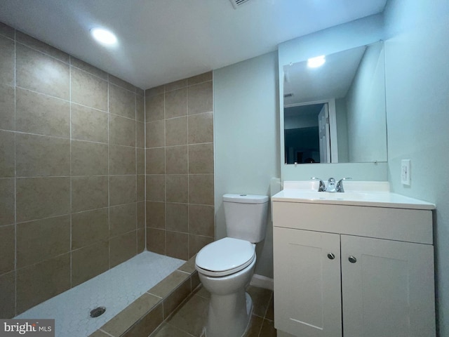 3801 Parkside Dr, Baltimore, MD 21206 - bathroom featuring toilet, tiled shower, vanity, and tile patterned flooring