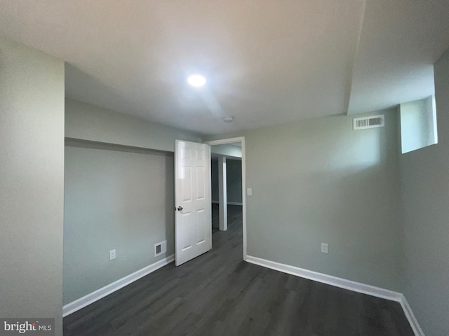 3801 Parkside Dr, Baltimore, MD 21206 - finished basement with baseboards, visible vents, and dark wood-style flooring