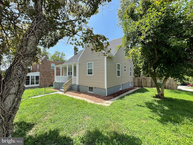 3801 Parkside Dr, Baltimore, MD 21206 - rear view of property featuring a lawn, fence, and roof with shingles