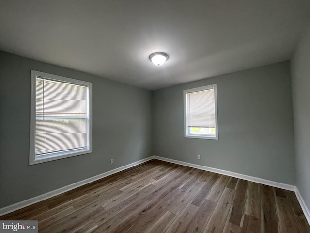 3801 Parkside Dr, Baltimore, MD 21206 - spare room featuring baseboards and dark wood finished floors